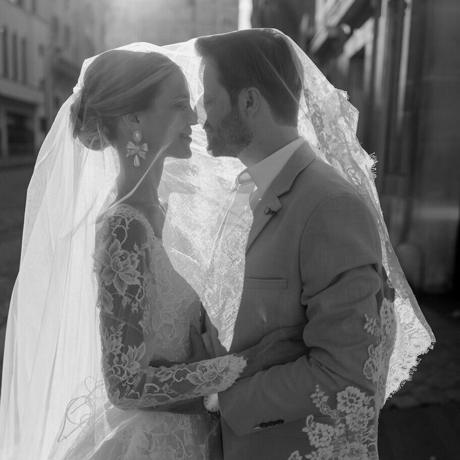 bride and groom in Paris, France under wedding veil looking at each other, during intimate wedding photos by Phoebe Lenderyou.